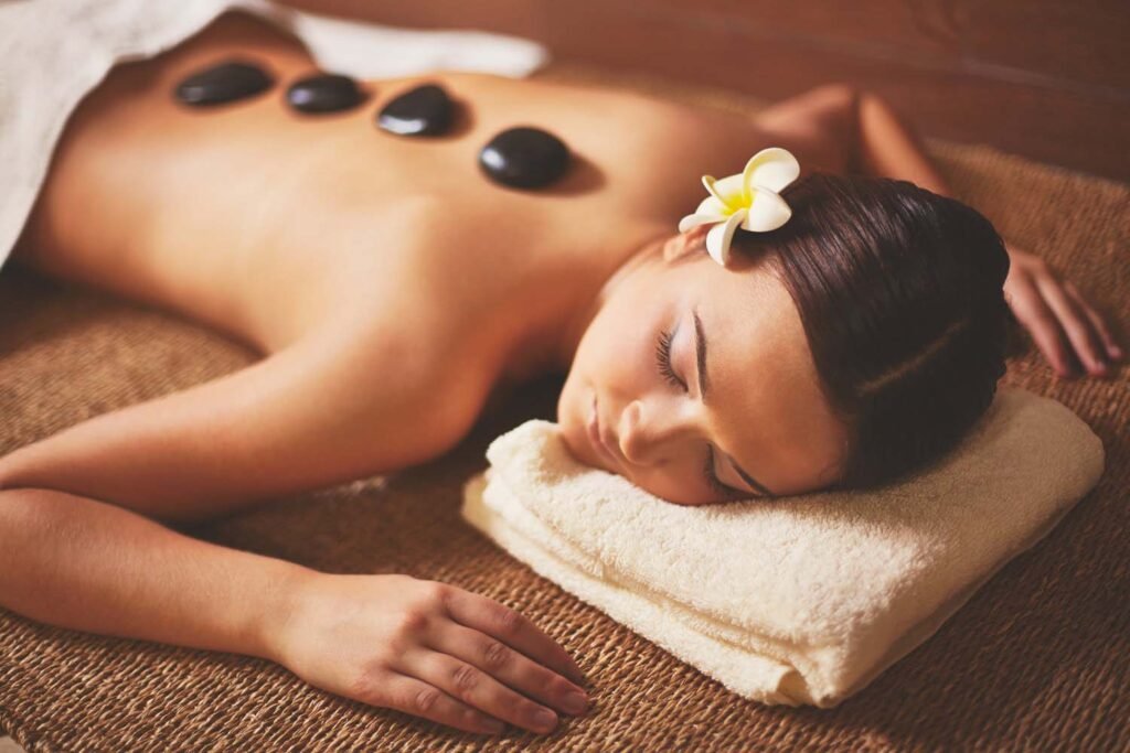 Facial massage, with Domy Beauty with the scent of flowers in the place and a purple stone on her forehead