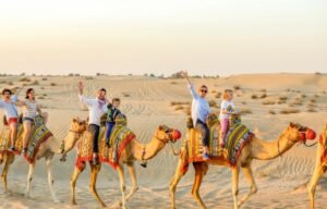 Family enjoying camel riding desert safari experience in Dubai Arabian desert